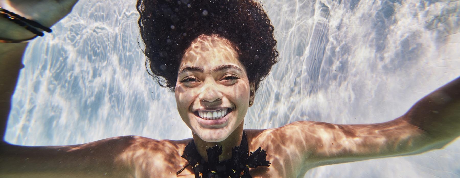 a smiling girl underwater