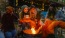 a group of women sitting around a fire